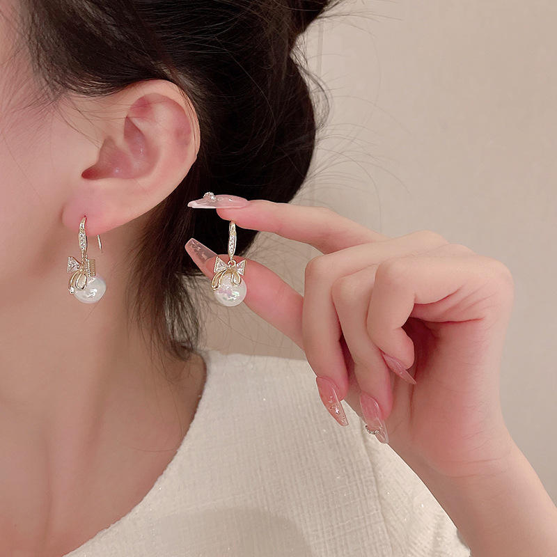 Golden and White Pearl Bow Tie Dangling Korean Fashion Earring